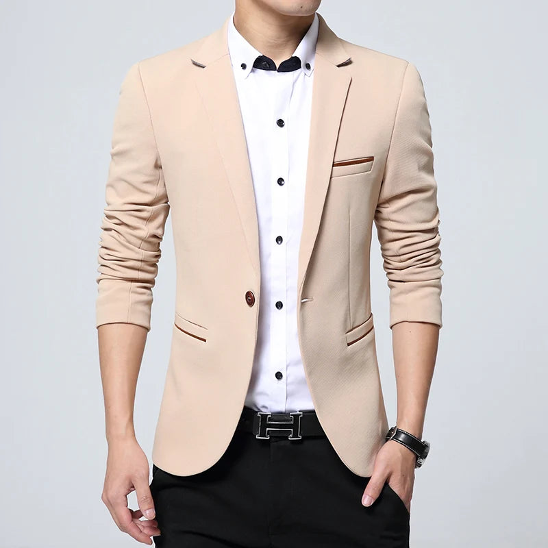 Beige blazer worn by a person on a light gray background