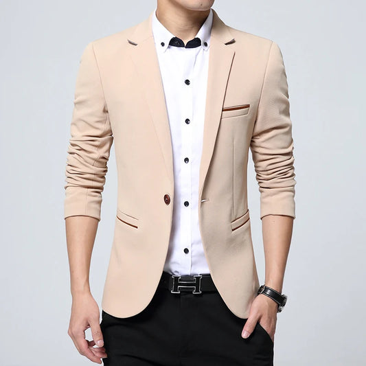 Beige blazer worn by a person on a light gray background