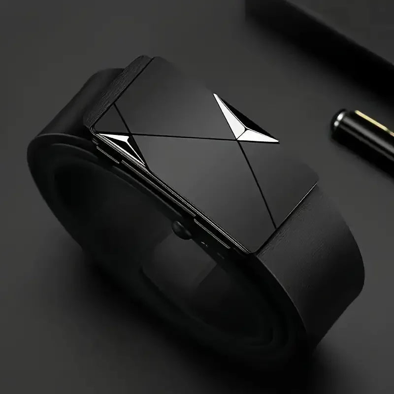 Black geometric object with metallic accents on a dark surface