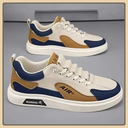 Pair of white sneakers with blue and brown accents on a gray background